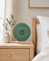 Golden Radiance original hand-painted mandala artwork displayed on a bedside table in a soft neutral bedroom by Sweet Lilly Loves