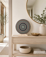 Copper Jewel round dot mandala artwork displayed on a timber stand atop a light console table by Sweet Lilly Loves