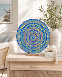Divine Tide of Gold original blue and gold dot mandala artwork displayed on a timber stand on a light dresser by Sweet Lilly Loves