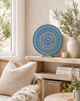Divine Tide of Gold original round mandala artwork displayed on a side table in a bright lounge setting by Sweet Lilly Loves