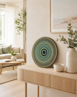 Golden Eclipse original teal, gold and black dot mandala artwork displayed on a light timber console by Sweet Lilly Loves