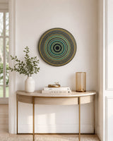 Golden Eclipse original hand-painted mandala artwork displayed on a slim console table in a bright neutral space by Sweet Lilly Loves