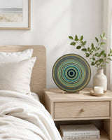 Golden Eclipse dot mandala artwork displayed on a bedside table in a soft neutral bedroom by Sweet Lilly Loves