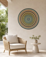 Golden Orange Orb original hand-painted orange and teal dot mandala artwork displayed above a neutral accent chair by Sweet Lilly Loves