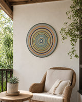 Golden Orange Orb hand-painted dot mandala wall art displayed in a soft neutral lounge corner by Sweet Lilly Loves
