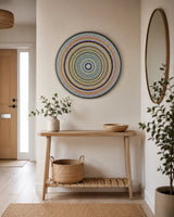 Golden Orange Orb orange and teal mandala wall art displayed above a console table in a hallway by sweet lilly loves