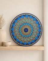 Just Blooming Golden Blue original round mandala artwork displayed on a light shelf in a calm neutral interior by Sweet Lilly Loves
