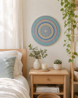 Ocean Whisper blue and gold dot mandala wall art displayed above a bedside table in a calm neutral bedroom by Sweet Lilly Loves
