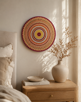Sunset Warm Winter Fire orange and gold dot mandala artwork displayed beside a neutral sofa in a warm interior by Sweet Lilly Loves
