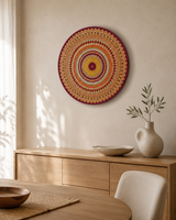 Sunset Warm Winter Fire orange and gold dot mandala artwork displayed above a timber console in a warm neutral interior by Sweet Lilly Loves