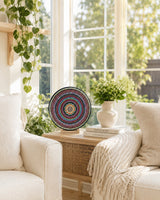 The Happy Centre colourful dot mandala artwork displayed on a stand beside a bright window seat by Sweet Lilly Loves