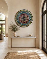 The Peacock Empress round dot mandala wall art displayed above a slim timber console in a bright hallway by Sweet Lilly Loves