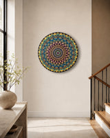 The Peacock Empress original round mandala artwork displayed on a light interior wall beside a staircase by Sweet Lilly Loves