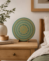 Verdant Glow round dot mandala artwork displayed on a small bedside table in a soft neutral bedroom by Sweet Lilly Loves
